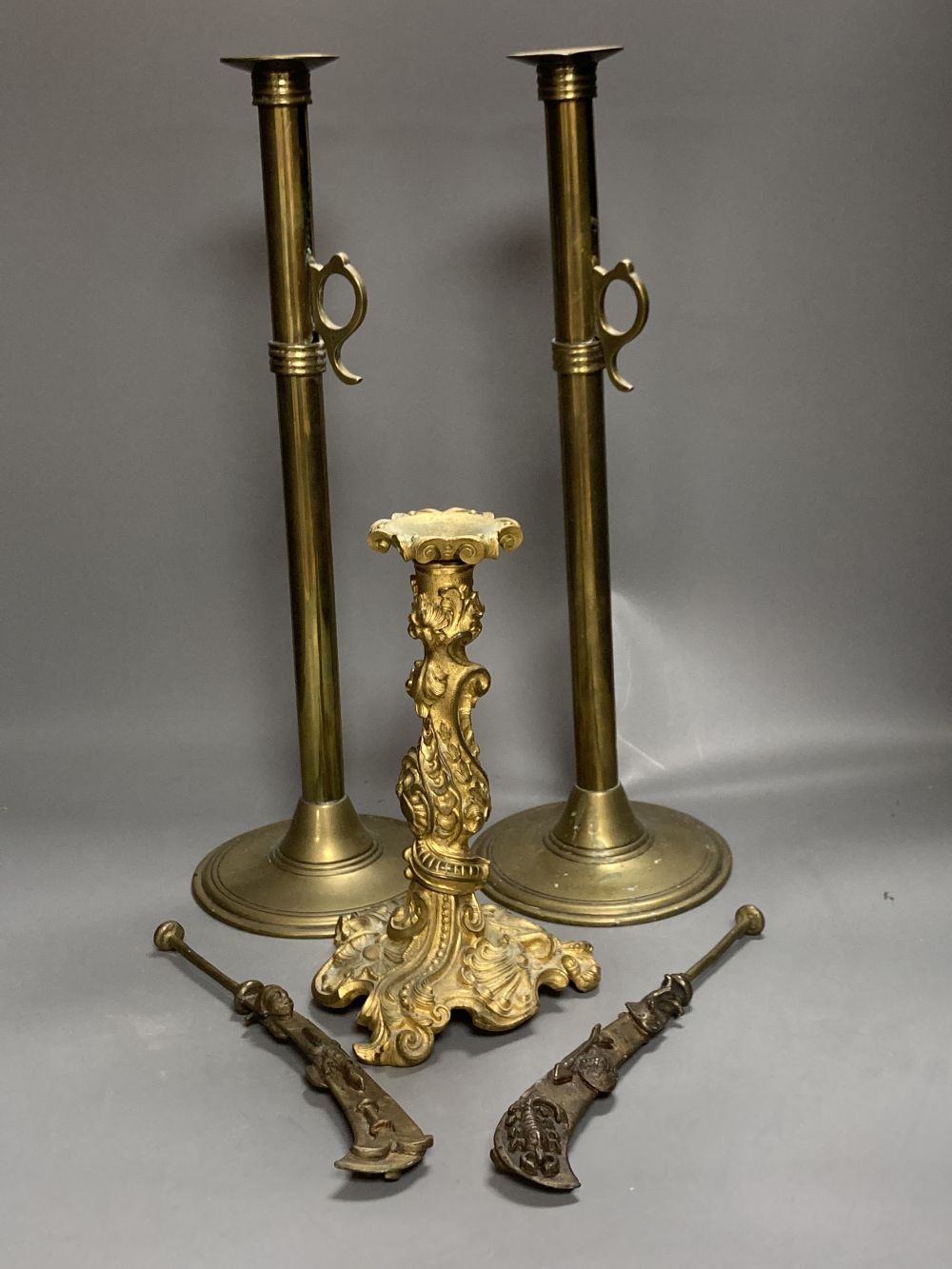 An 18th century French ormolu candlestick, 25cm, a pair of 19th century tubular brass ejector candlesticks, 46cm and two Chinese brass
